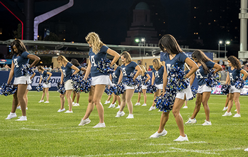 Argos cheerleaders performing at the football game wearing custom t-shirts.