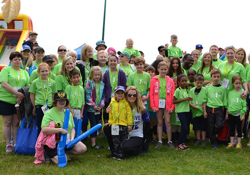 Group of participants in the walk to cure diabetes wearing green custom printed t-shirts.