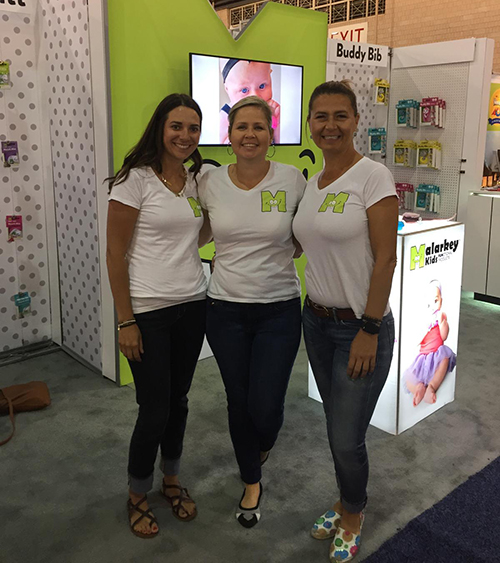 Company showcasing their services at a tradeshow wearing custom t-shirts with their company logo.