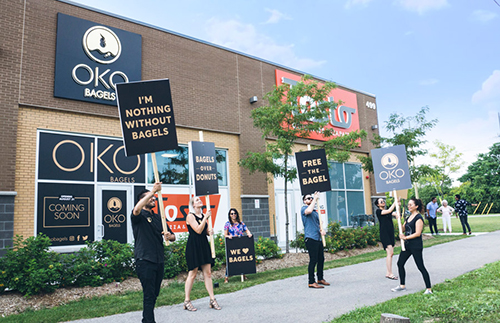 Entripy customer wearing black custom t-shirts with their custom logo advertising for their new business.