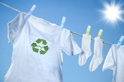 Reduce reuse and recycle white tshirts drying outside in sun