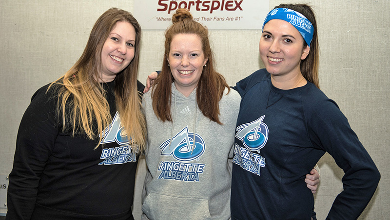 Ringette Alberta players wearing custom sweatshirt and custom t-shirts at ringette game.