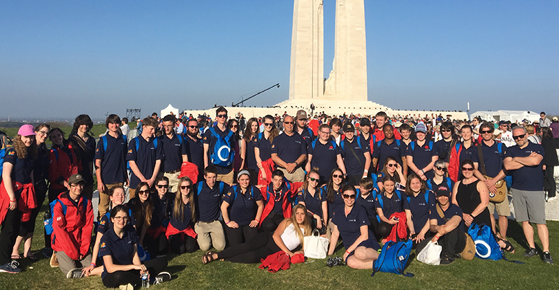 Students wearing navy blue custom polos with Canada 150 logo printed on their sleeves.