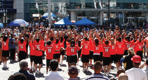 Crowd of youth day volunteers wearing custom t-shirts with personalization printed on the back for each participant.