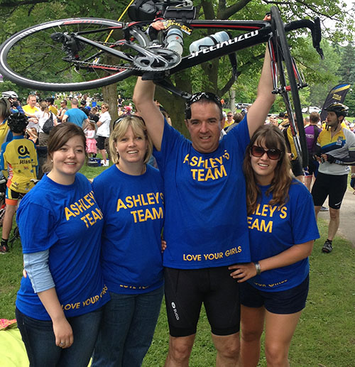 Bike ride charity event with a family wearing a purple customized t-shirt representing their family.