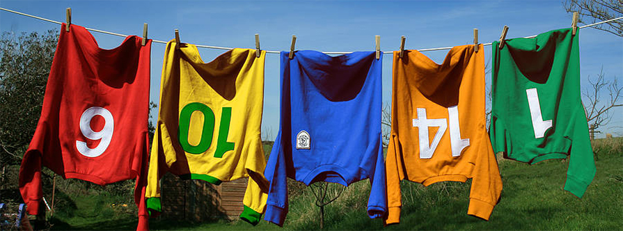 Hanging colourful custom jerseys with personalized numbers and custom logo for teams.