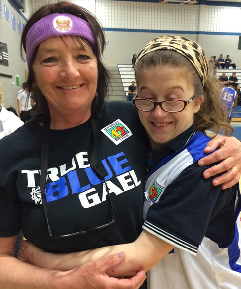 Best Buddies volunteer and student in the non-profit organization program wearing custom t-shirts.