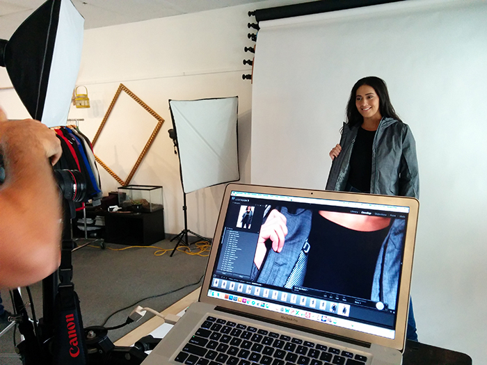 Model posing custom jacket for photoshoot capturing close up showing inside the jacket.