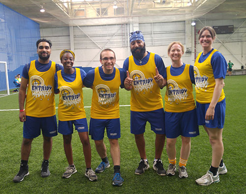 Entripy employees competing at a work event wearing custom jerseys.