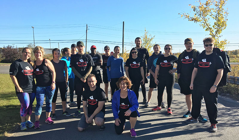 Group of participants in a non-profit organization wearing custom printed t-shirts and embroidered caps.