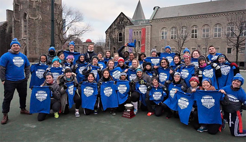 Group of participants displaying blue custom printed t-shirts and custom toques.