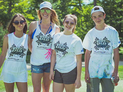 Group of kids ready to participate in the boat rally for kids wearing white custom t-shirts and embroidered caps.