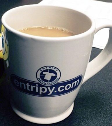 Entripy branded custom mug used as promotional products for giveaways to clients and employees.