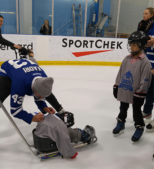 Maple Leafs player Kadri is signing kids custom jerseys at the Easter Seals Skate.