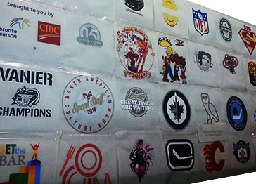 Variety of custom designs printed on custom apparel. Previously designed logos printed as a collage on the wall.