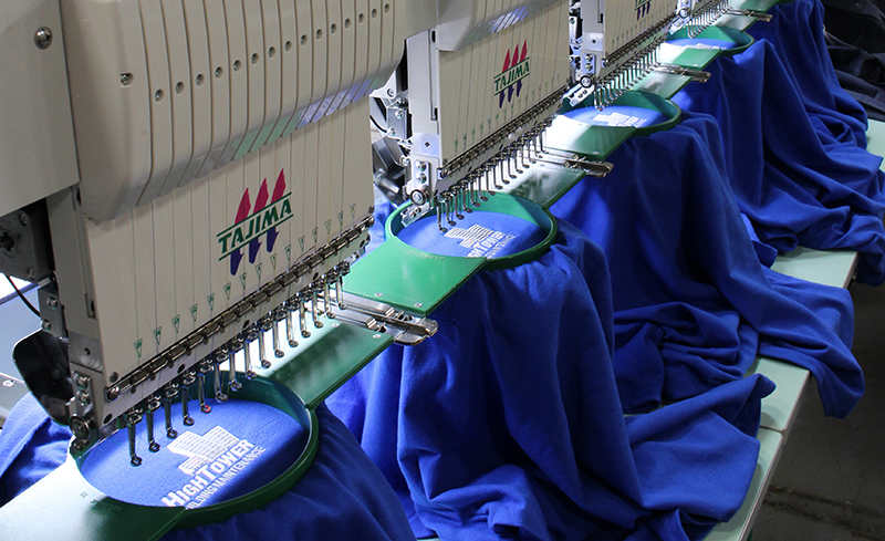 Entripy's new embroidery machine printing custom polo shirts for clients.