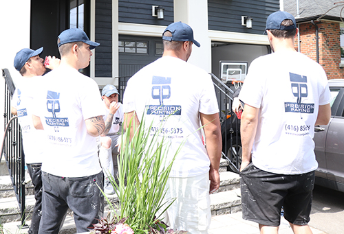 Company wearing custom uniforms with their company logo on their customized t-shirts and custom hats.