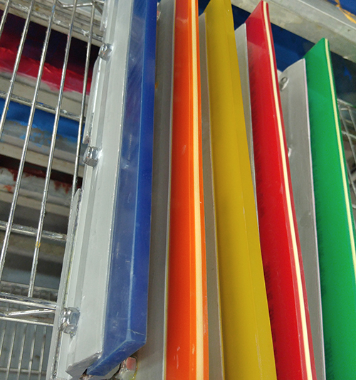 Squeegies drying from manually screen-printing custom printed t-shirts.