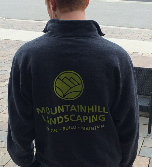 Client wearing custom sweatshirt with company logo printed on full back.