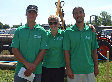 Staff displaying custom golf shirts with custom embroidered company logo.