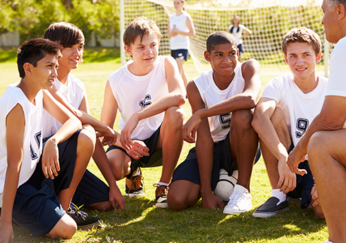 Tag-less white sleeveless custom jerseys worn by soccer players.