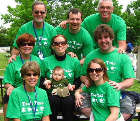 Family wearing bright green printed personalized t-shirts at a charity event.