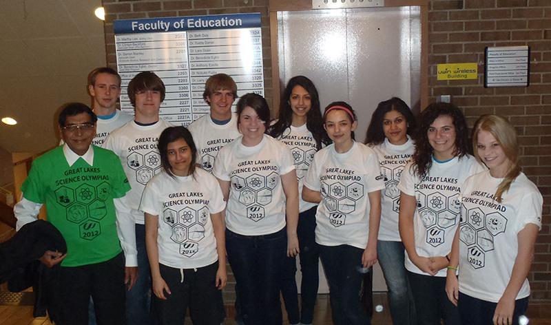 Great Lakes Science team is displaying their white and green custom printed t-shirts at school.