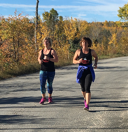 Participants wearing custom tank tops at a non-profit organization marathon for veterans.