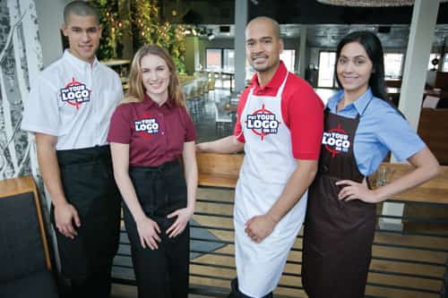 Chefs cooking in the kitchen wearing custom uniform.